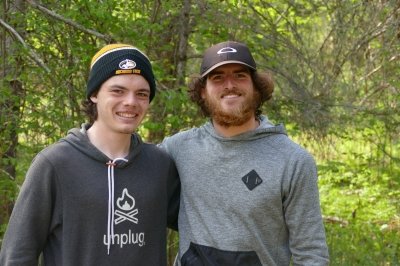 Two Michigan Tech students on a research expedition smile in the forest at Isle Royale.