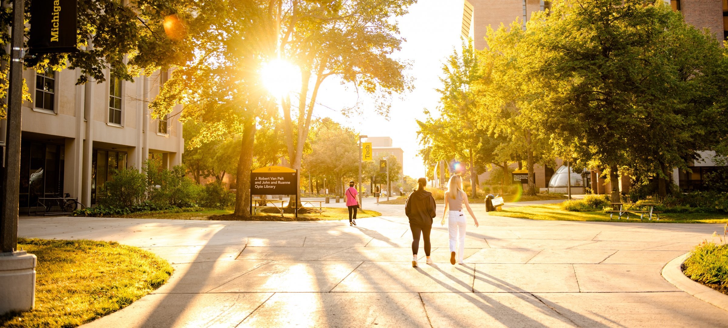 Michigan Technological University's campus at dawn with students walking