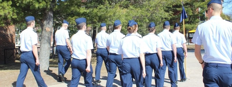 Cadets in uniform marching on campus for Lead Lab, during a warmer day of a U.P. winter.