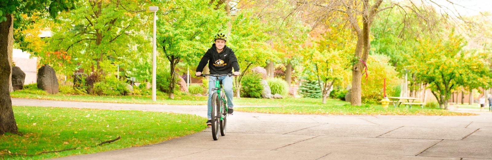 Student biking on Michigan Tech's Campus.