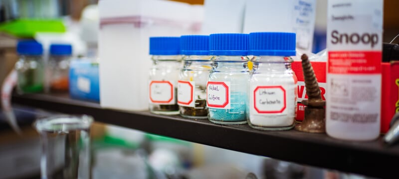 Chemicals safely stored in glass containers labeled