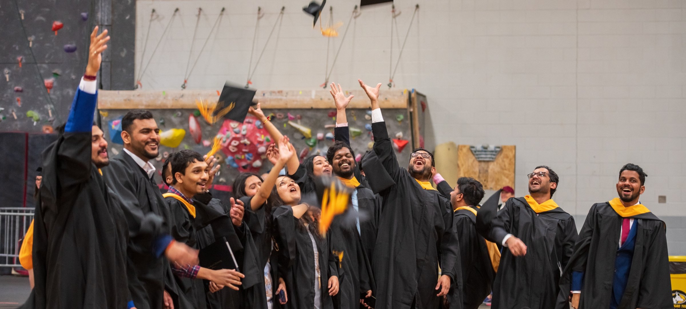 Graduate candidates throwing up caps in the air
