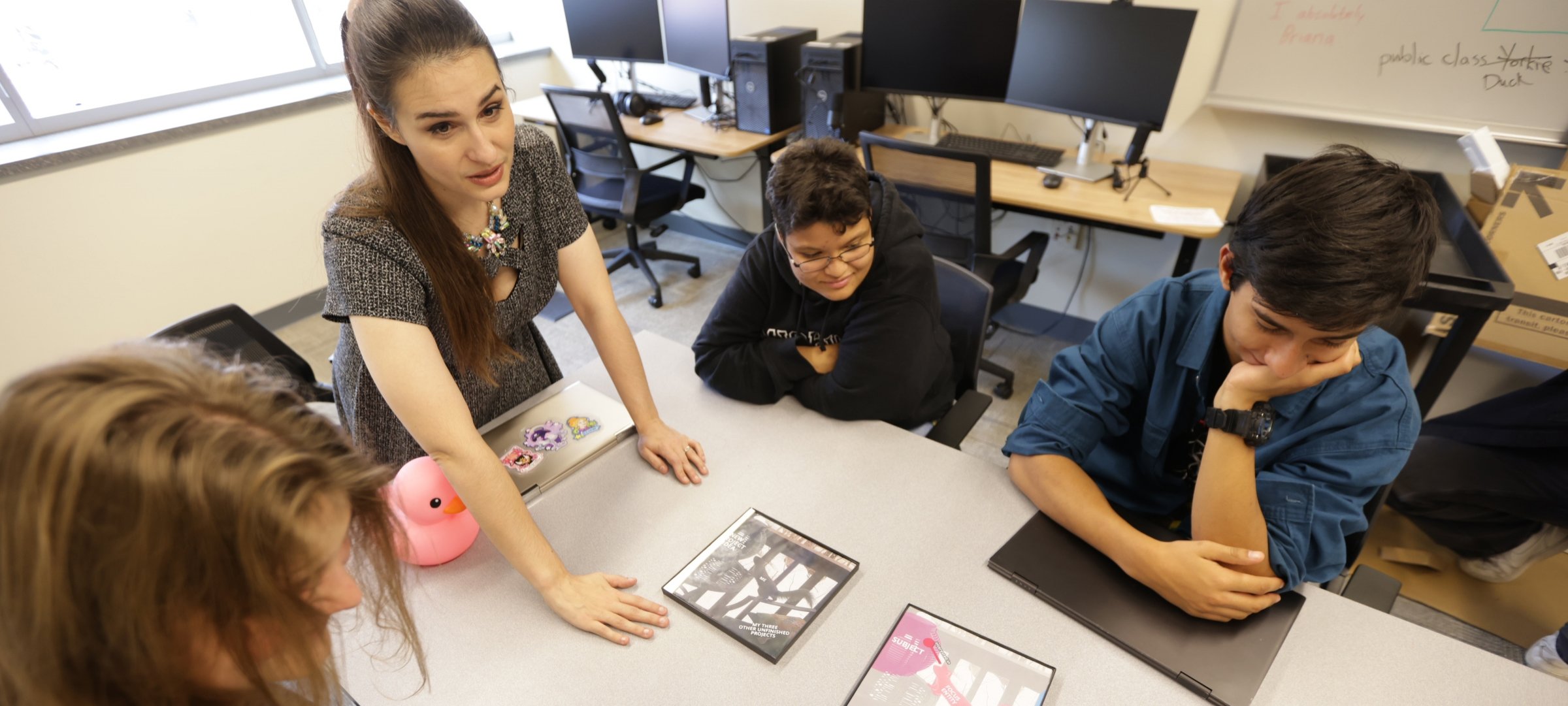 CS instructor Briana Bettin and undergraduate students learn about programming.