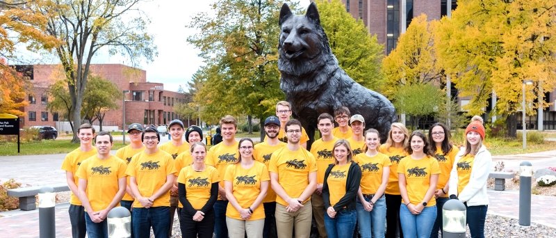 The LEAP group poses by the Husky statue on the campus of Michigan Tech.