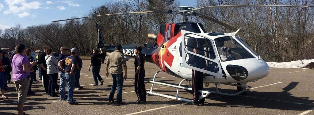 Trainees standing around an EMS helicopter