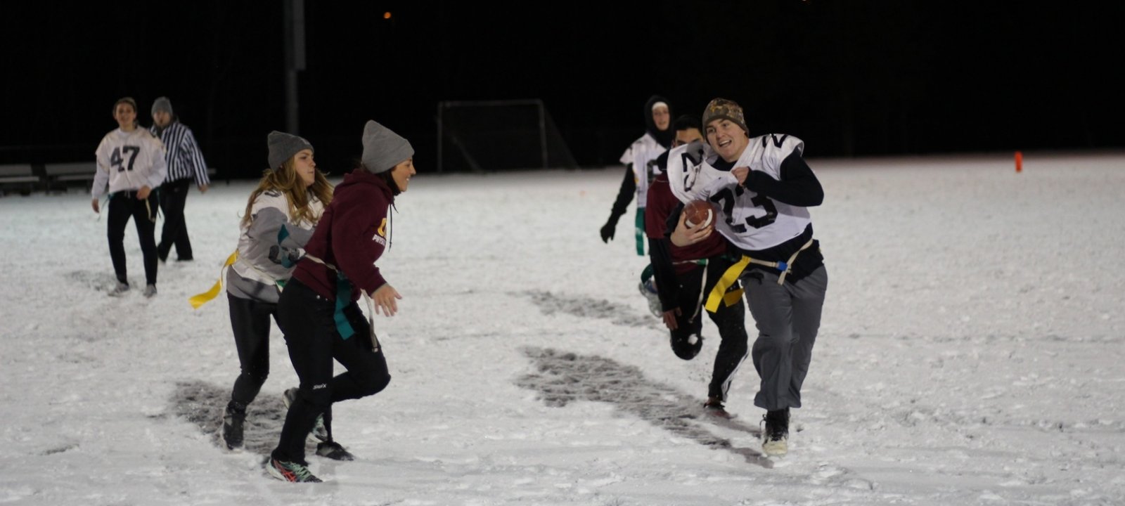Michigan Tech Students playing flagg football in snow