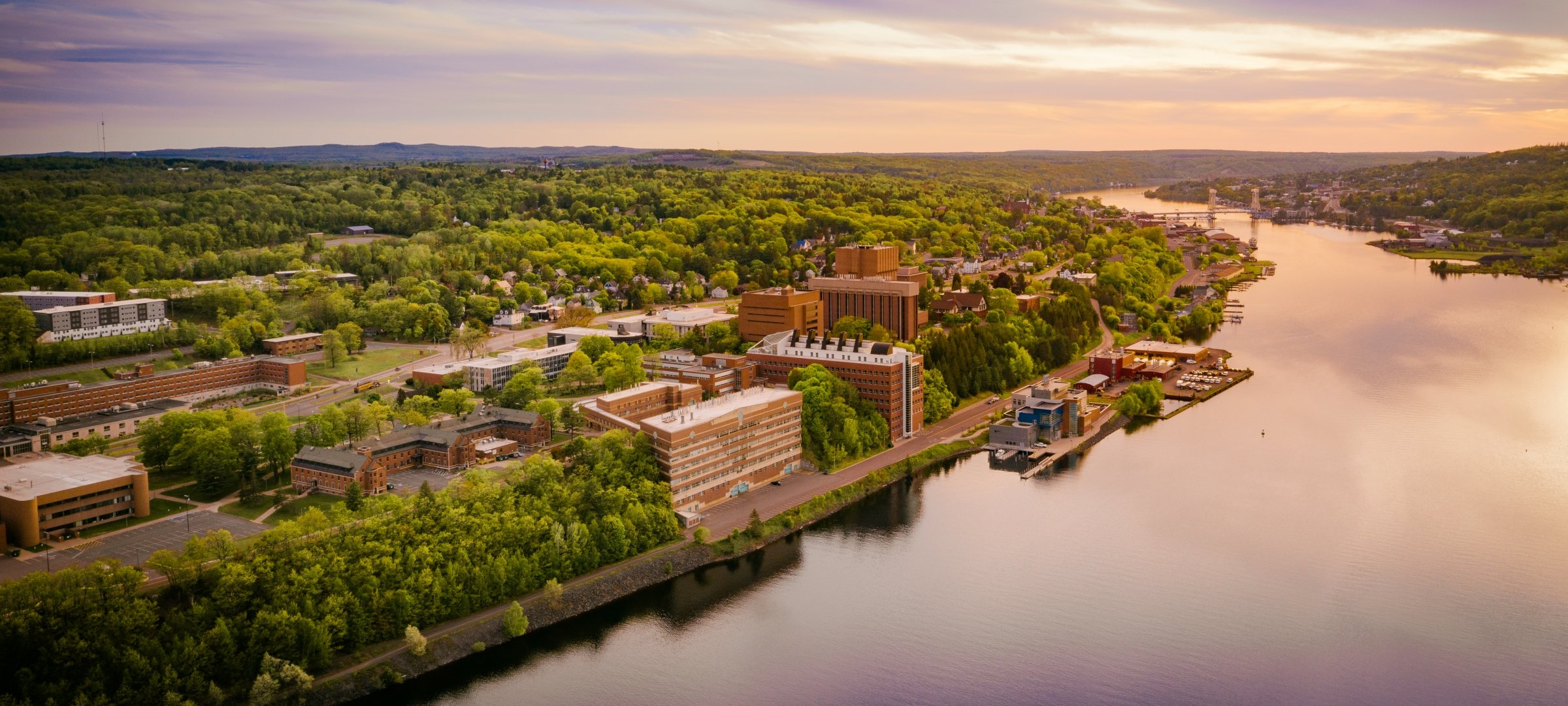 Aerial view of Michigan Tech's campus during a sunny summer day near sunset.