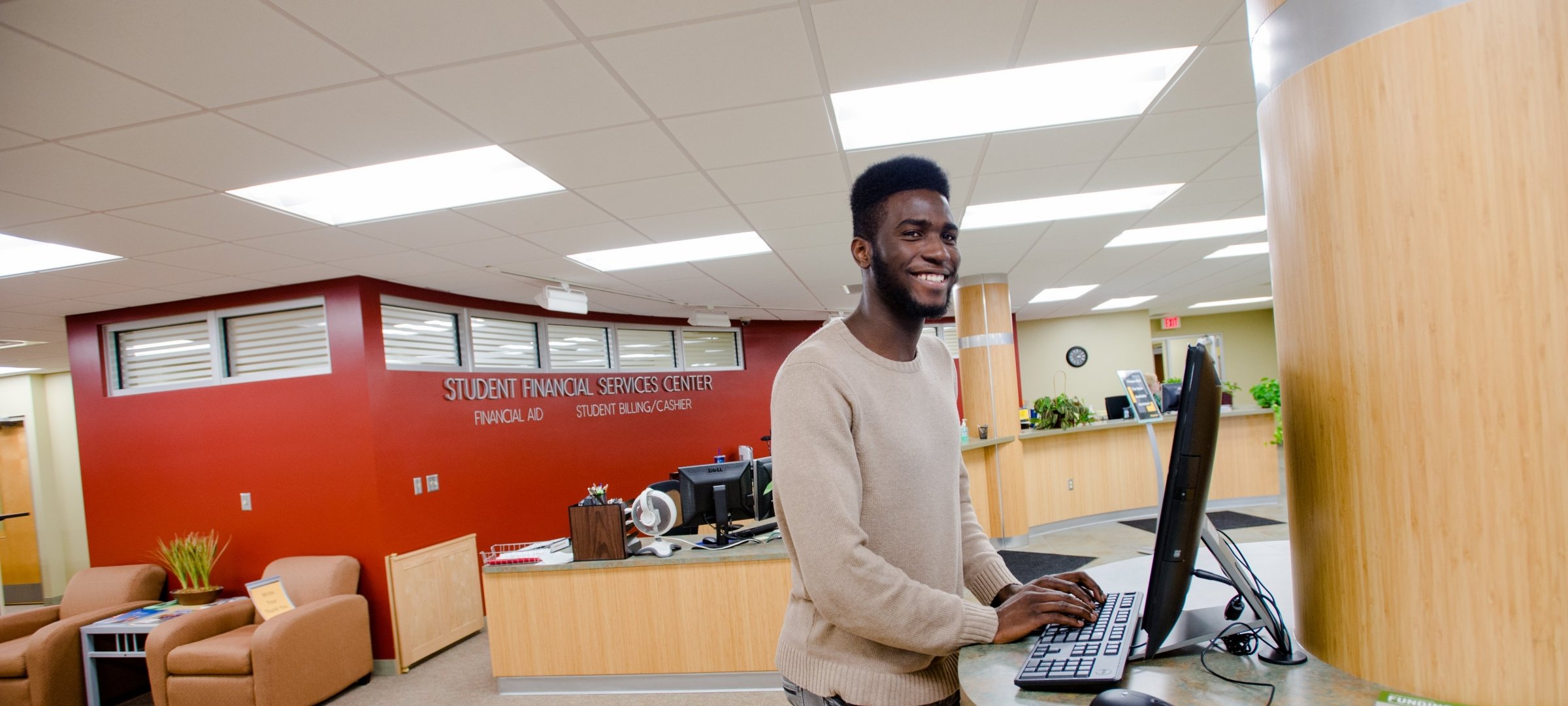 Student at a computer in the Financial Aid office.