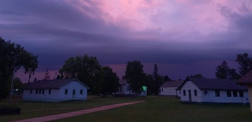 Old houses at the Ford Center with a purple sunset sky.
