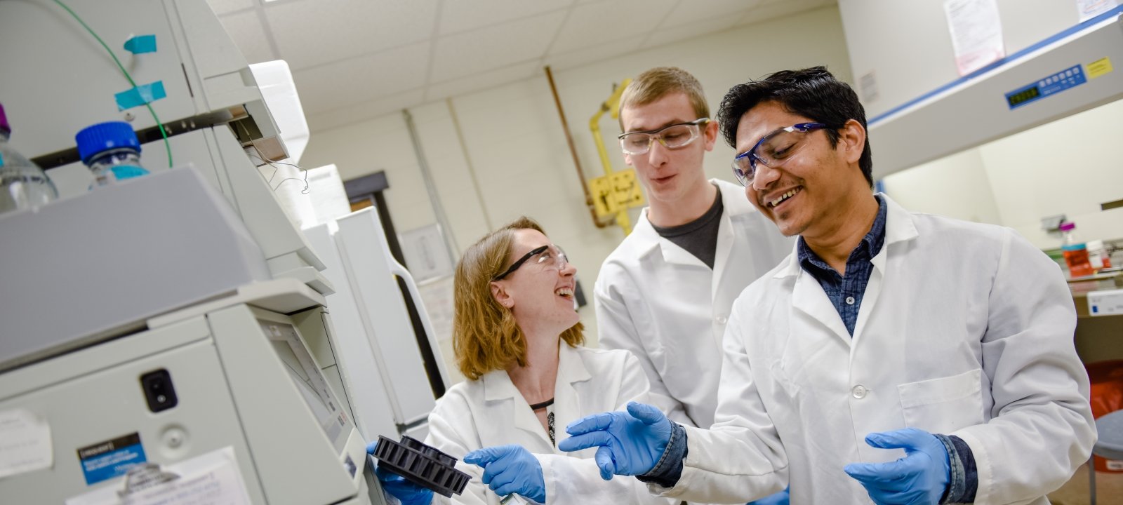 three researchers work in a laboratory setting. 