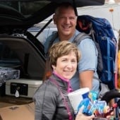 Parents unload a minivan during move-in weekend.