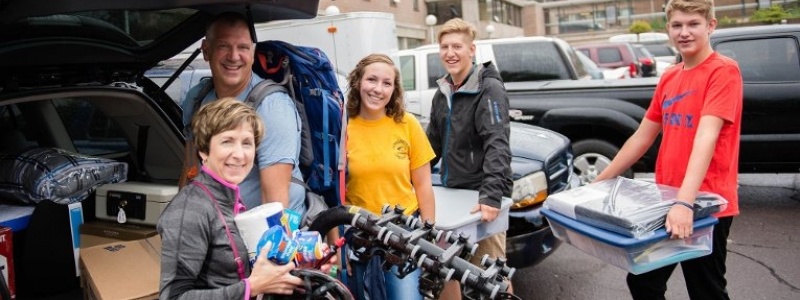 Parents and students unload a minivan on move-in day.