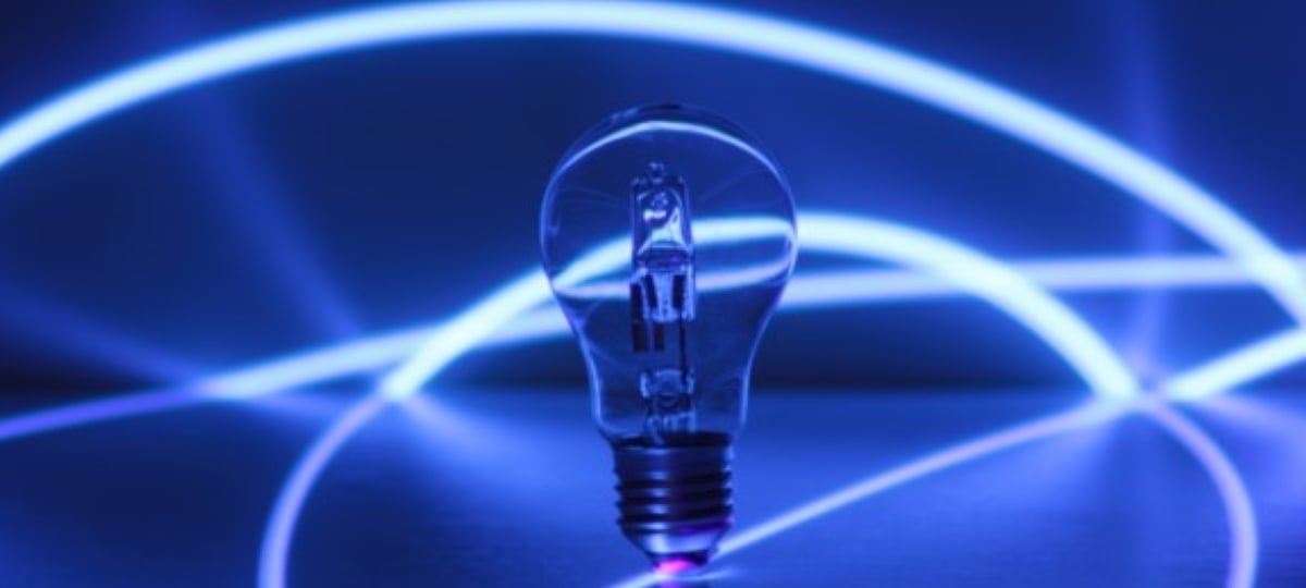 Close-up of a lightbulb against an electrified background.