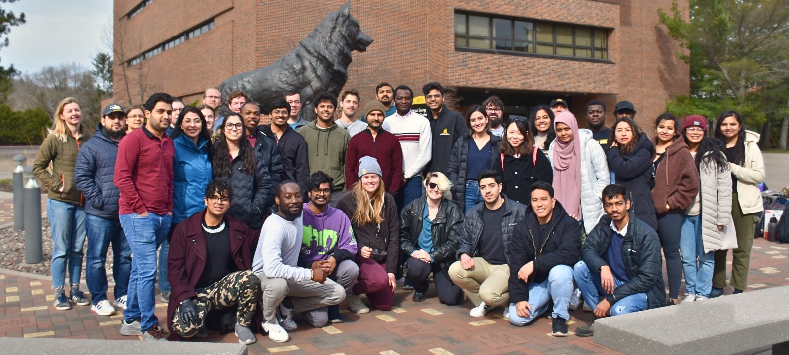 GSG members grouped in front of husky statue outdoors