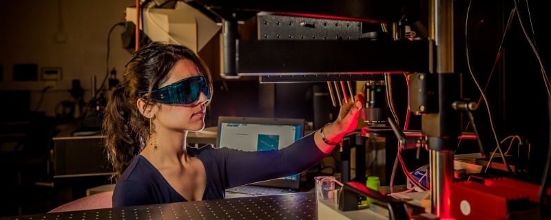 Graduate student working with lasers.