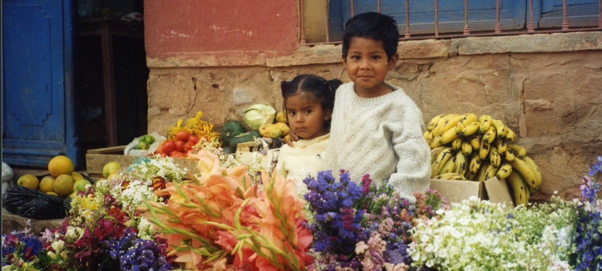 Two children at a street-side stall in Bolivia