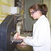 Student working at a machine in a lab.