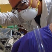 Student setting up tubes in a lab.