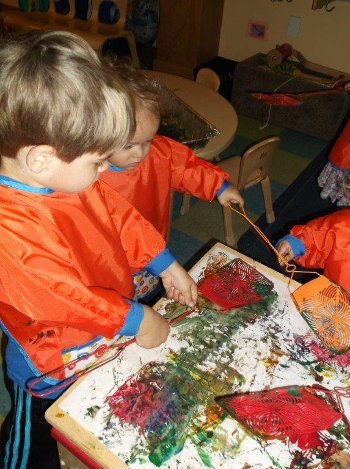 Children painting with flyswatters.