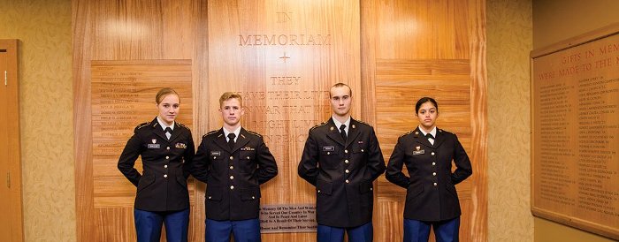 ROTC students in front of the War Memorial Wall in the Memorial Union Building.