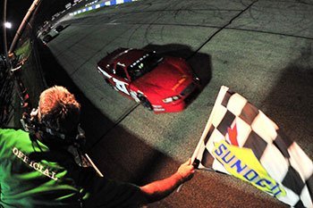 Reagan May crosses the finish line to take the checkered flag.