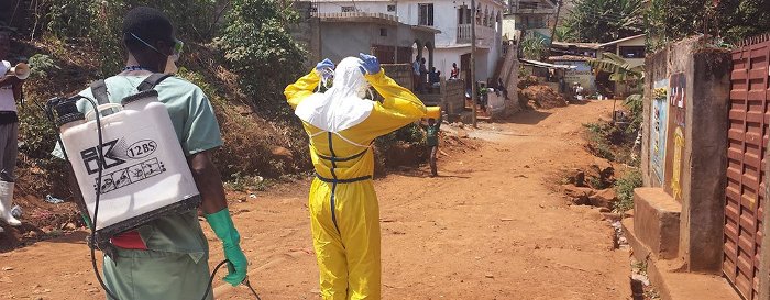 Suited up for household decontamination in Freetown, Sierra Leone.