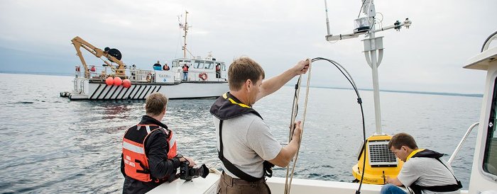 Crews work to deploy a buoy in the Straits of Mackinac.