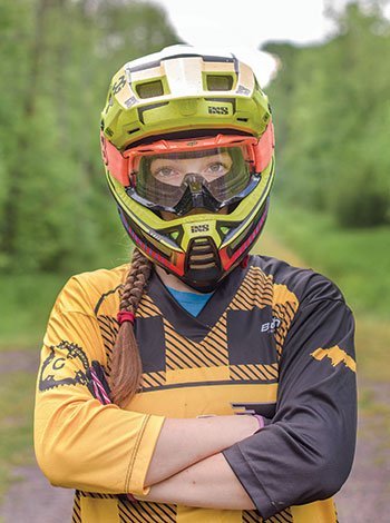 Emily wearing a biking helmet and goggles.