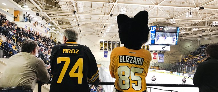 Blizzard and President Mroz watching a hockey game.