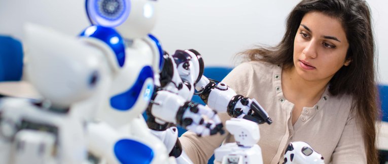 Female student working with robots.