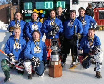 Broomball team wearing medals with the trophy.