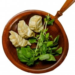 Three dumplings with a side of greens.