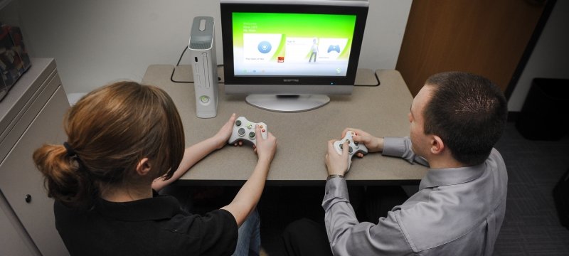 Two students playing a video game.