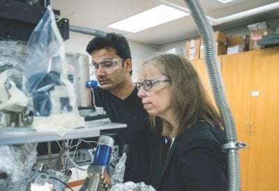 Kathryn Perrine and Chathura de Alwis working in the lab.
