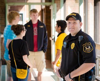Photo of  Officer Reid DeVoge with some students