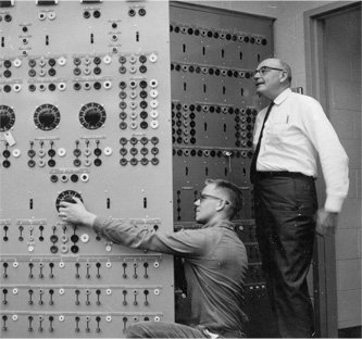 Professor William Longacre instructing a student in operating an electrical control panel