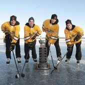 Huskies hockey players on the frozen Portage Lake with the MacInnes Cup.