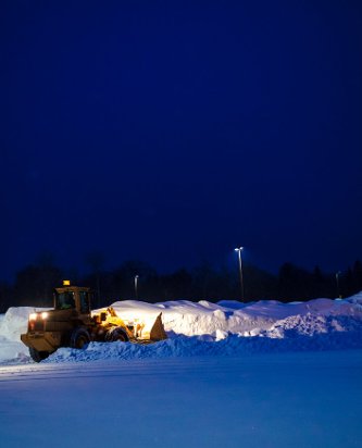 A front-end loader making room for the next storm