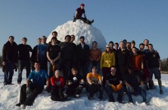 Students standing around a 32.94ft snowball.