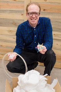 Pearce holding 3d printer filament created from recycling plastic milk jugs