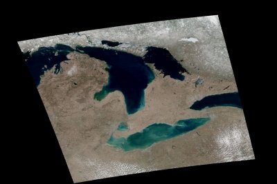 A satellite image of the Great Lakes shows green and blue areas of plant productivity.