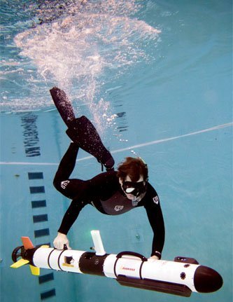 Researcher Colin Tyrrell chaperones Michigan Tech?s AUV in the University diving pool.