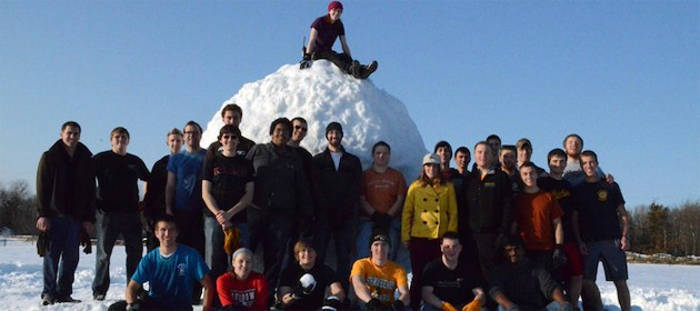 Michigan Tech students gather around the Guinness World Record snowball they created last spring.