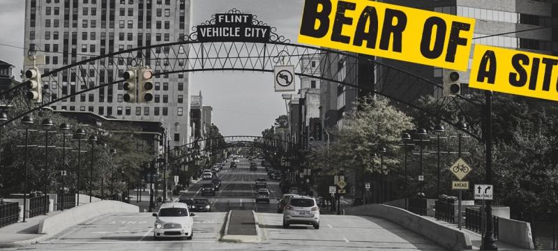 Bear of a Situation text over a view down a Flint street.