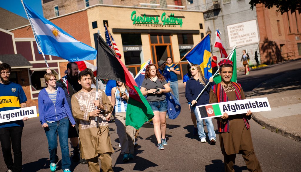 Students and community members proudly carry their flags in the Parade of Nations.