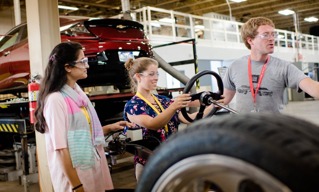 From the left, Aleeha Azhar, Kaleigh Pare and instructor Chris Morgan take a hands-on look at automotive engineering.