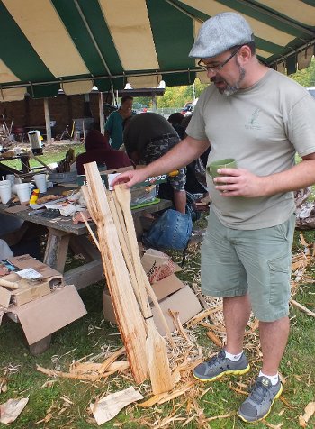 Rice camp teacher Scott Herron checks out the workmanship on a parching paddle during a tool-making session in Alberta, Michigan. Herron and co-teacher Roger LaBine lead weekend-long camps on all aspects of ricing. 