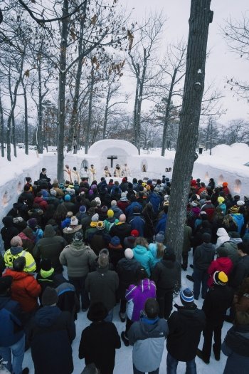 People in an outdoor snow chapel 