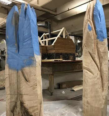 blue and white wooden stands that look like mountains in a basement work area