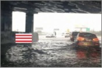 flooded parking garage with red and white gauge overlay in center left